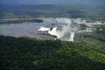 roaring waterfalls in the wild jungle from a helicopter
