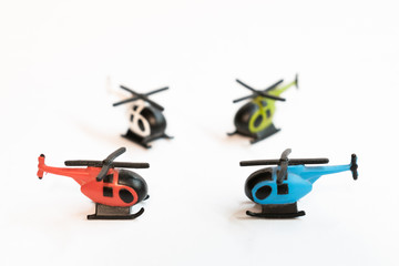 Small colorful helicopter toys isolated on a white background - air travel by helicopter concept