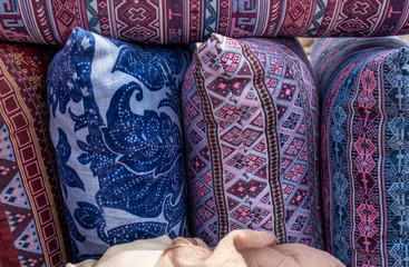 Handmade pillows in colorful  embroidered pillowcases for sale at local street market