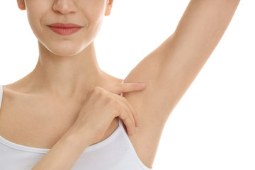 Obraz na płótnie Canvas Young woman showing armpit with smooth clean skin on white background, closeup