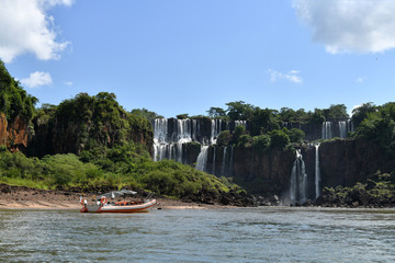 a trip to the roaring waterfalls on the river in a motor boat in a national park in brazil