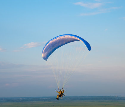 Paraglider With A Motor In The Evening Sky.