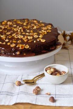 Vegan brownie cake with hazelnuts and salted caramel n white cakestand