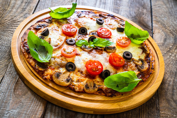 Margherita pizza on wooden background