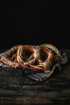 German Bread Pretzel and Bagel Breakfast on a wooden table. Black Background