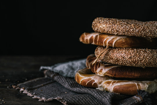 German Bread Pretzel and Bagel Breakfast on a wooden table. Black Background.