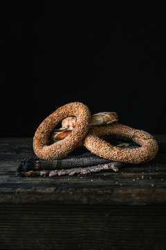 German Bread Pretzel and Bagel Breakfast on a wooden table. Black Background.