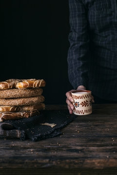 German Bread Pretzel and Bagel Breakfast on a wooden table. Black Background.