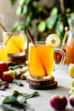 Hot apple cider in glass mugs in bright sunlight