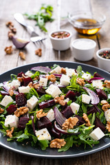  Beetroot salad with goat cheese on wooden background