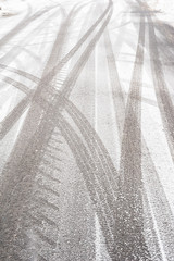 Tire tracks on a city road covered by snow. Cold winter day.