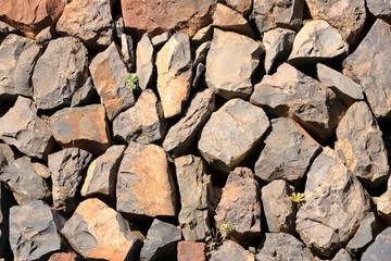Texture of a red orange granite stone wall for background