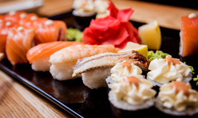Sushi set. Rolls with salmon, eel and red caviar on a wooden plate. Restaurant.