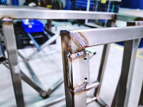 Close-up Welded Stainless Steel Square Tube Frame and Plate with Selective Focus