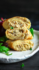 thin pancakes or crepes stuffed chicken meat and vegetables (hen or turkey) menu concept background. top view. copy space for text