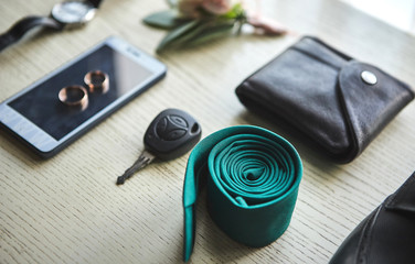 different accessories of a businessman for creating a style of a people lie on a wooden background