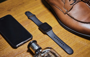 different accessories of a businessman for creating a style of a people lie on a wooden background