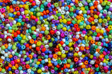 Fototapeta na wymiar Macro photography of some colorful beads of different shape used for manufacturing jewerly and accesories.