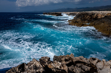 Waves crash on the rocky shore of the Mediterranean Sea on the Akamas Peninsula in the northwest of the island of Cyprus.