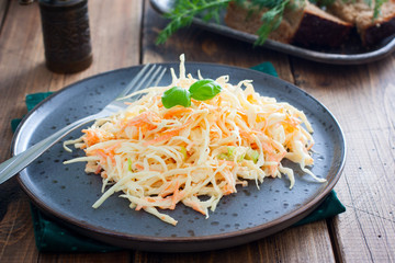 Cole slow salad with white cabbage and carrots, selective focus