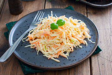 Cole slow salad with white cabbage and carrots, selective focus
