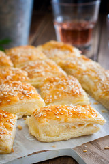 Puff pastry pie with cheese, sprinkled with sesame seeds, selective focus