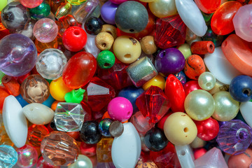 Macro photography of some colorful beads of different shape used for manufacturing jewerly and accesories.