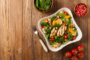 Traditional Greek salad with grilled Halloumi cheese with basil. Top view. Flat lay.