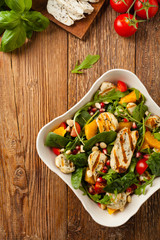 Traditional Greek salad with grilled Halloumi cheese with basil. Top view. Flat lay.