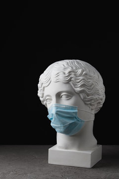 Medical Mask On An Antique Statue. Virus Epidemic Medical Care