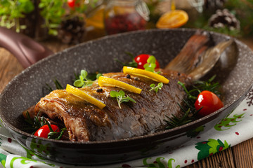 Fried carp whole. Served with lemon and cherry tomatoes.