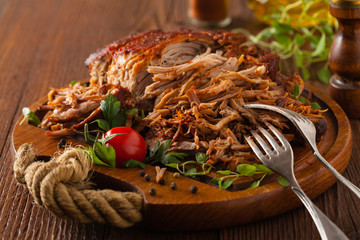 Pulled pork on a wooden board.