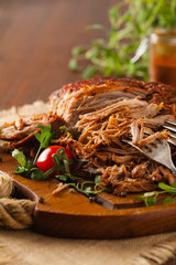 Pulled pork on a wooden board.