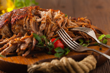 Pulled pork on a wooden board.