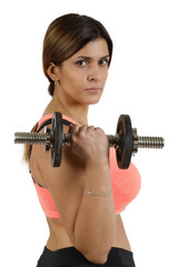 Portrait of young adult woman in sports uniform with dumbbells in her hands