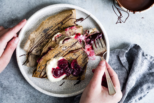 Toasty and nutty buckwheat crepes topped with roasted cherries, whipped cream, and bittersweet chocolate. A naturally gluten-free decadent dessert.
