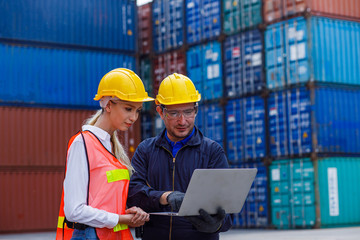 Two dock worker discuss inspect relay checking information data logistics on a tablet computer in a...