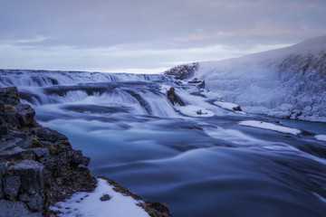 Long exposure photograph of the Icelandic Gullfoss waterfall on a cold winter day