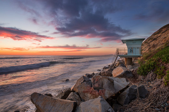 Sunset at beach od West Coast in California with lifeguard tower, USA