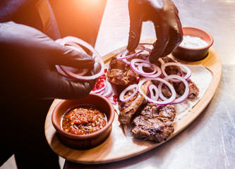 Chef cooking delicious beef and pork barbecue on grill. Georgian restaurant.
