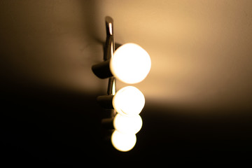 Some warm light bulbs mounted on a ceiling in a house - Electricity and illumination concept,...