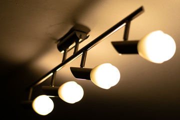Some warm light bulbs mounted on a ceiling in a house - Electricity and illumination concept,...