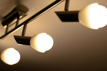 Some warm light bulbs mounted on a ceiling in a house - Electricity and illumination concept, Bucharest, Romania