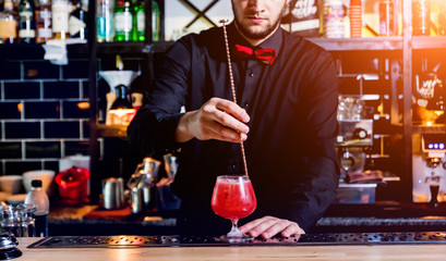Bartender is making cocktail at bar counter. Fresh cocktails. 