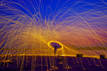 Burning Steel Wool spinning. Showers of glowing sparks from spinning steel wool