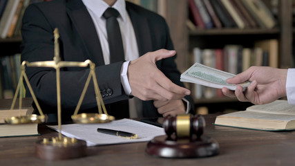 Close up Shoot of Judge Hand Receiving Money on Office Table