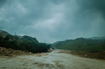 Cycling mountain road. Misty mountain road in high mountains.. Cloudy sky with mountain road