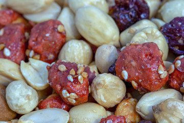 Macro photography of a heap of mixed nuts and cranberries.