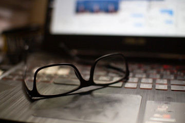 glasses and pen on laptop  Rest your eyes after working