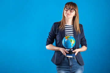 travel agent girl with passports tickets and globe on a blue background. travel concept